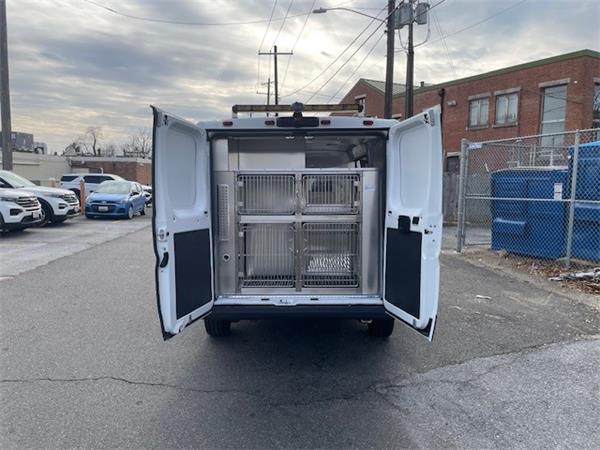 2023 Dodge ProMaster 3500; white, no branding; back is fully outfitted for animal transport